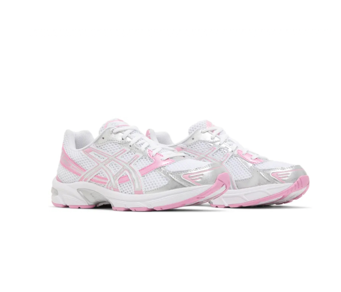 White and pink running shoes with mesh fabric, silver accents, and a flexible sole for comfort and support.