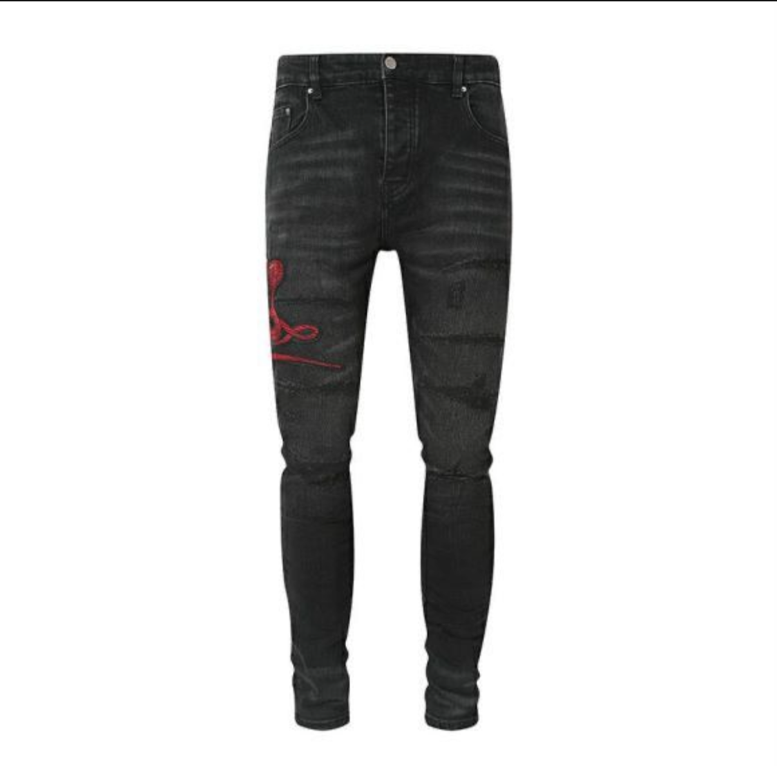 A pair of black skinny jeans with distressed details and red snake embroidery on the left thigh.
