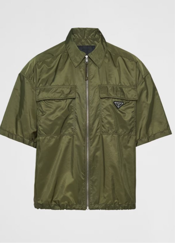 Olive green short-sleeve jacket with a front zipper and a small Prada logo on the chest.