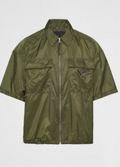 Olive green short-sleeve jacket with a front zipper and a small Prada logo on the chest.