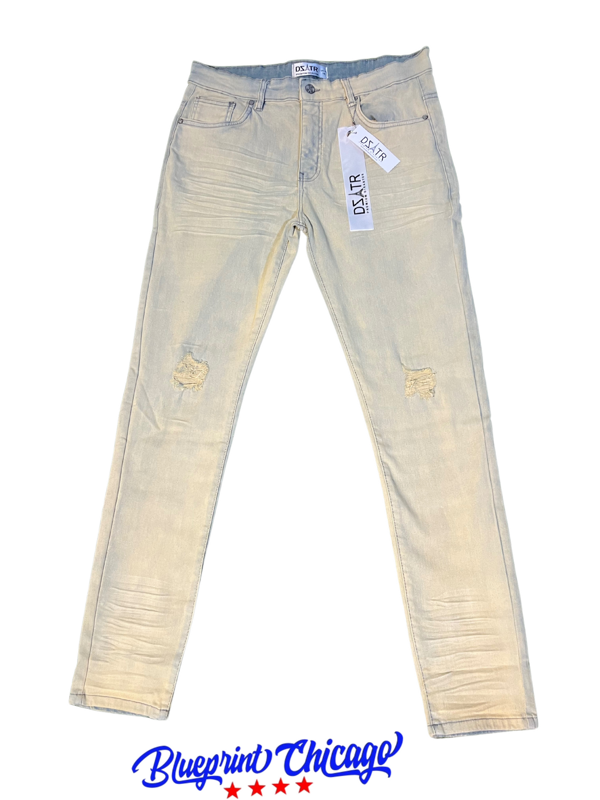 Light-washed distressed denim jeans with rips, featuring a tag and Blueprint Chicago logo at the bottom.