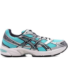 A side view of a turquoise and silver ASICS running shoe with mesh detailing, reflective stripes, and a cushioned sole for comfort.