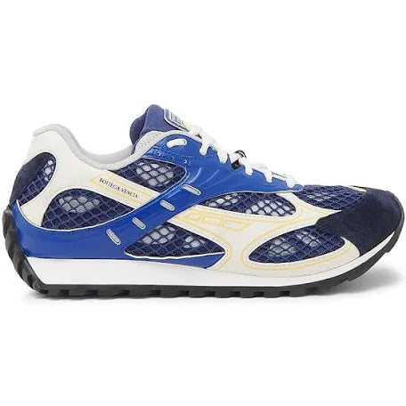 A pair of blue and white luxury sneakers with mesh detailing, suede accents, and a sleek, athletic design from Bottega Veneta.