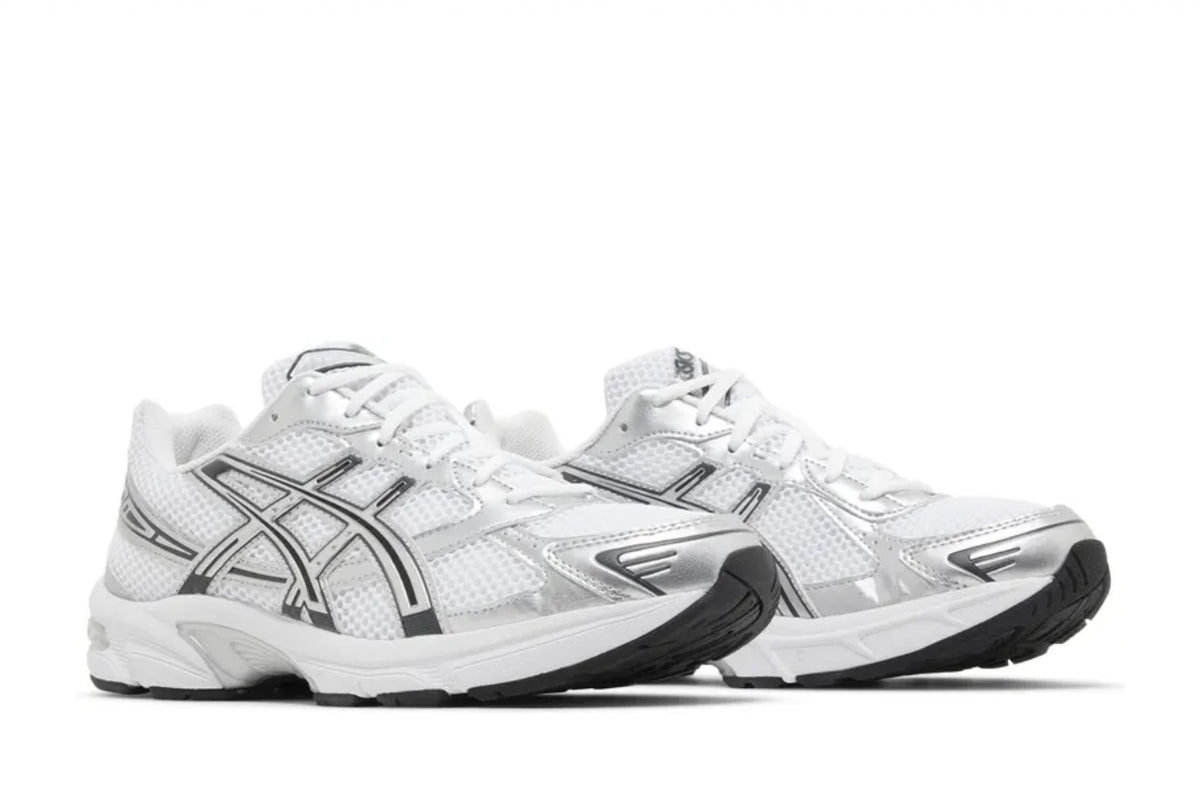 A pair of white and silver Asics sneakers featuring a sleek design with mesh and metallic accents, along with a black rubber sole.