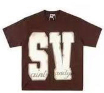 A brown Saint Vanity t-shirt with large "SV" lettering on the front and "saint vanity" text in a smaller font below.
