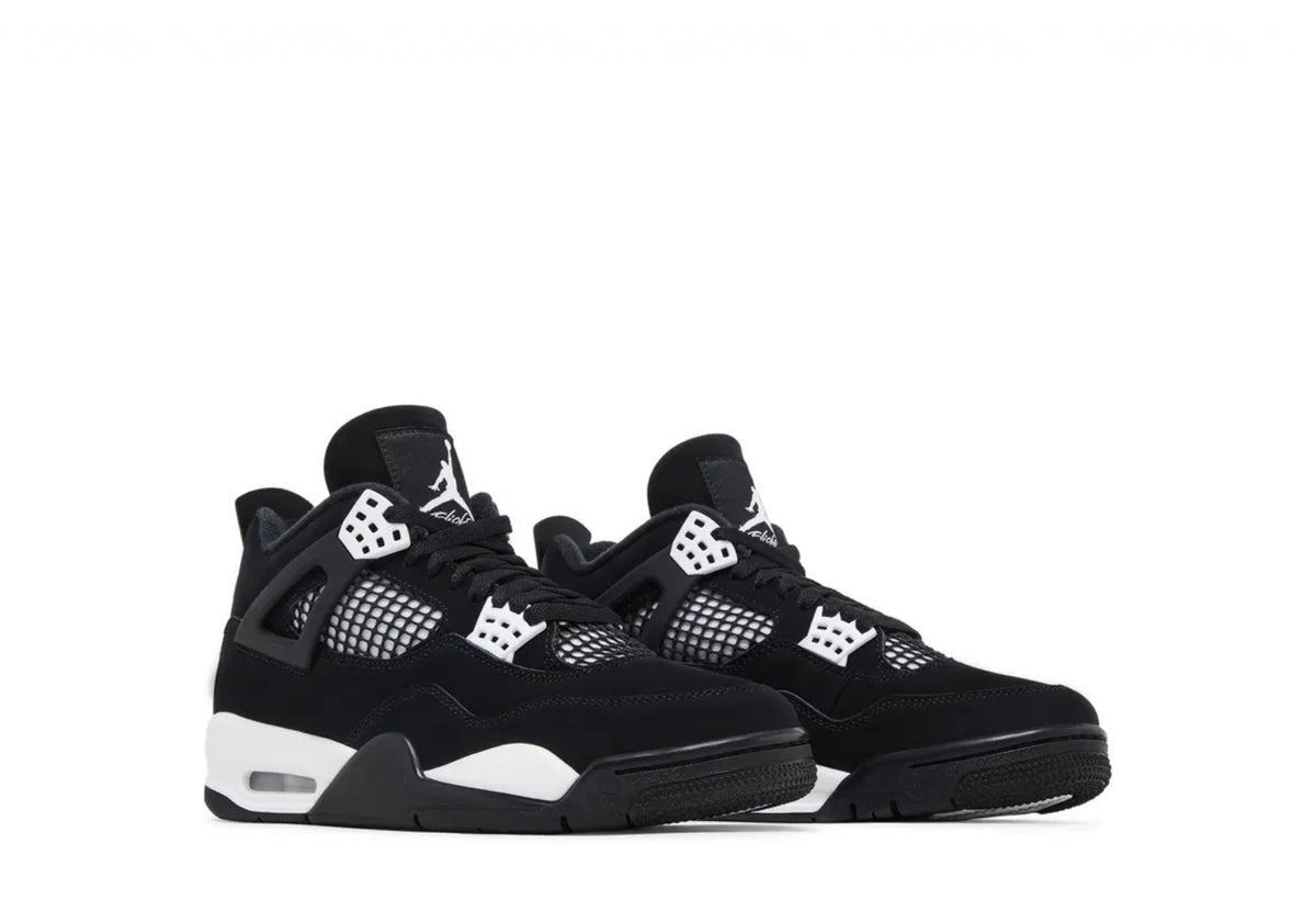 Pair of black and white Air Jordan 4 sneakers with mesh panels, black laces, and white sole accents on a white background.