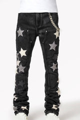 Black jeans with large star-shaped patches in shades of gray and silver, accompanied by a chain accessory on the side.