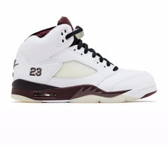 Side view of Air Jordan 5 sneaker in white with burgundy midsole, black laces, mesh panel, and number 23 stitched near the heel.