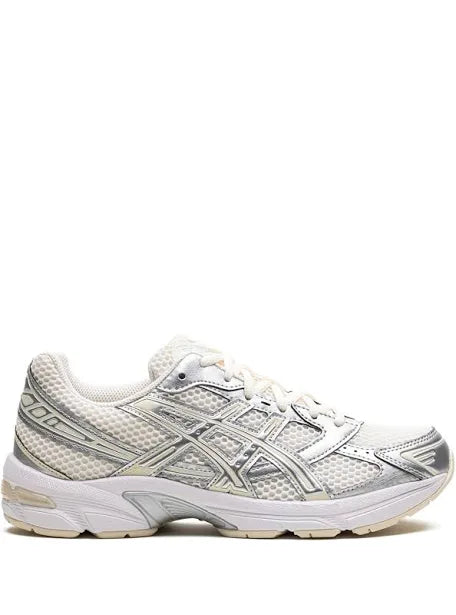 A side view of a white and silver ASICS running shoe with mesh detailing, a cushioned sole, and the brand's logo on the side.