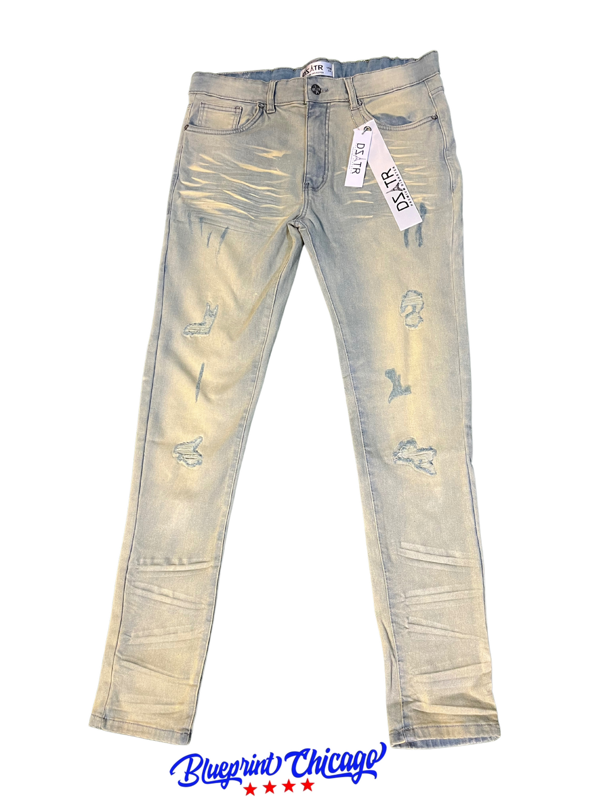 A pair of light blue distressed jeans with a faded design, featuring rips and a "DSATR" brand tag, displayed with a "Blueprint Chicago" label.