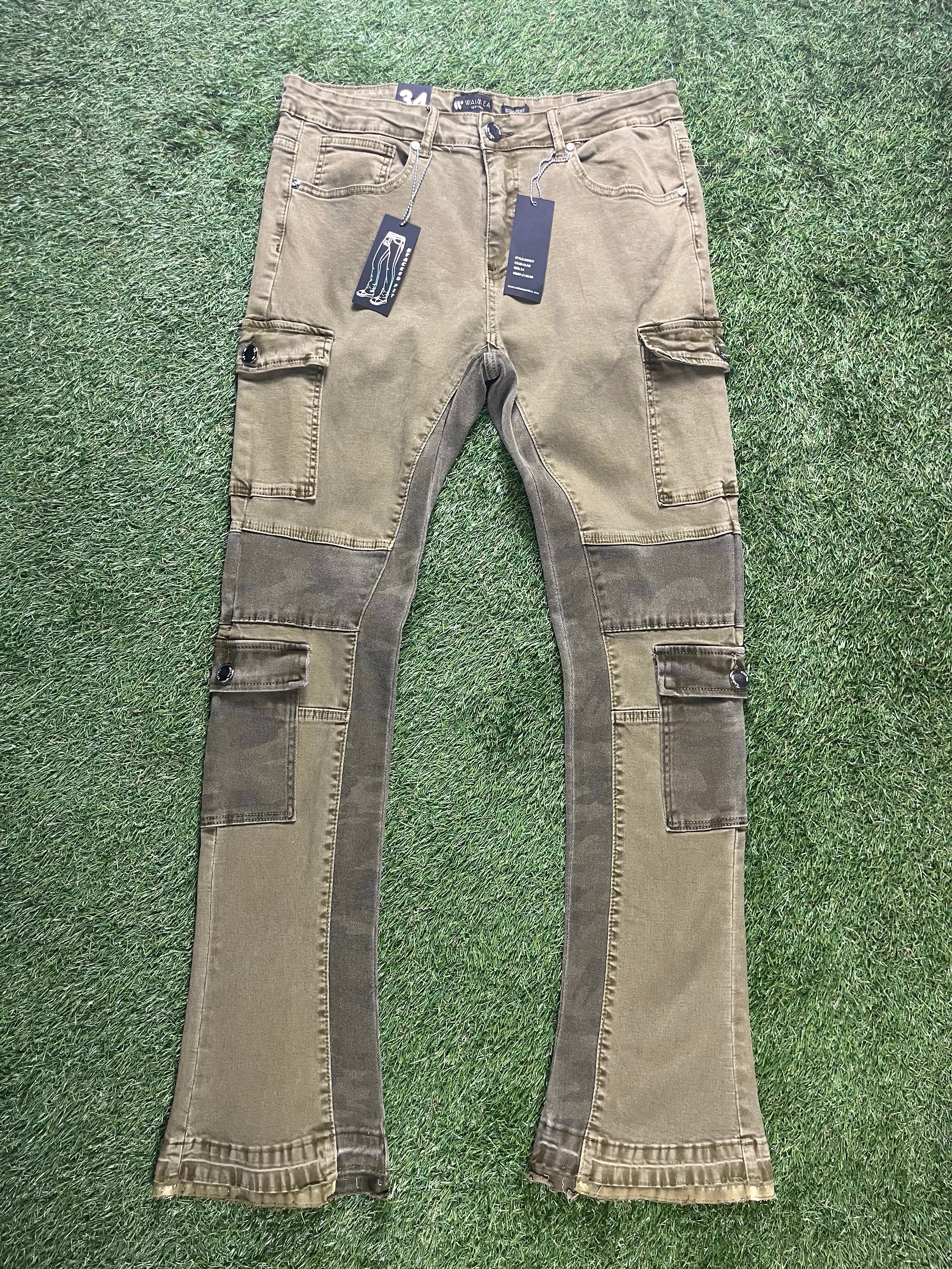 A pair of olive green cargo pants featuring side pockets, camouflage panels, and two black tags hanging from the waistband.
