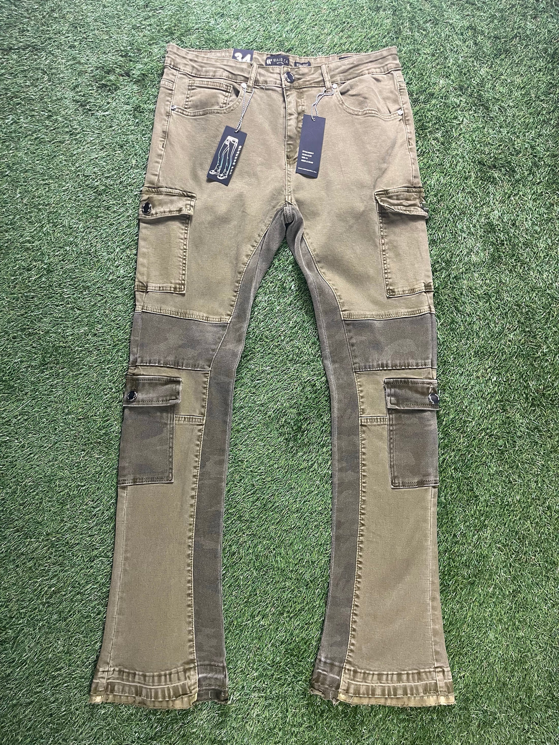 A pair of olive green stacked cargo pants with multiple side pockets and a relaxed fit, featuring the "Blueprint Chicago" logo at the bottom.