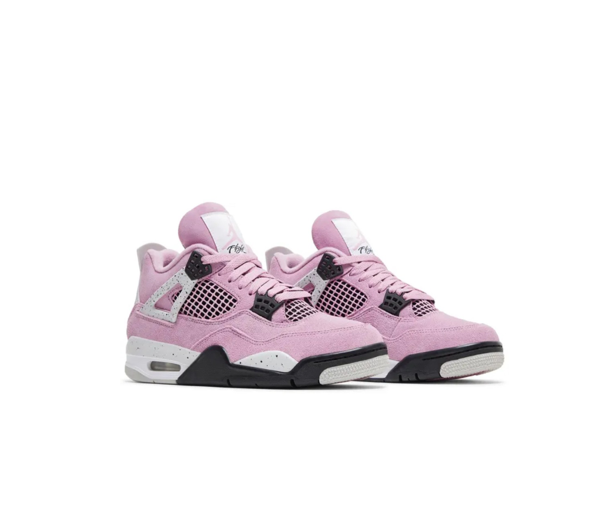 A pair of pink Air Jordan 4 sneakers with black and gray accents, featuring mesh panels and a white midsole.