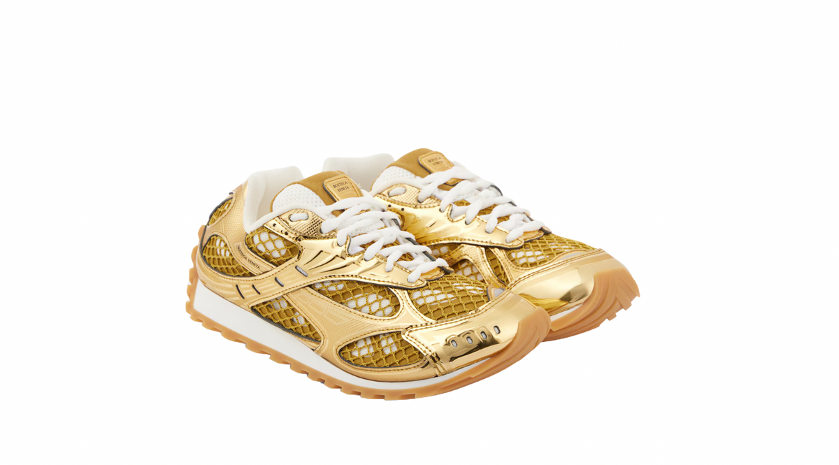 Gold and white sneakers with mesh and metallic details, featuring a beige sole and white laces, from Bottega Veneta.