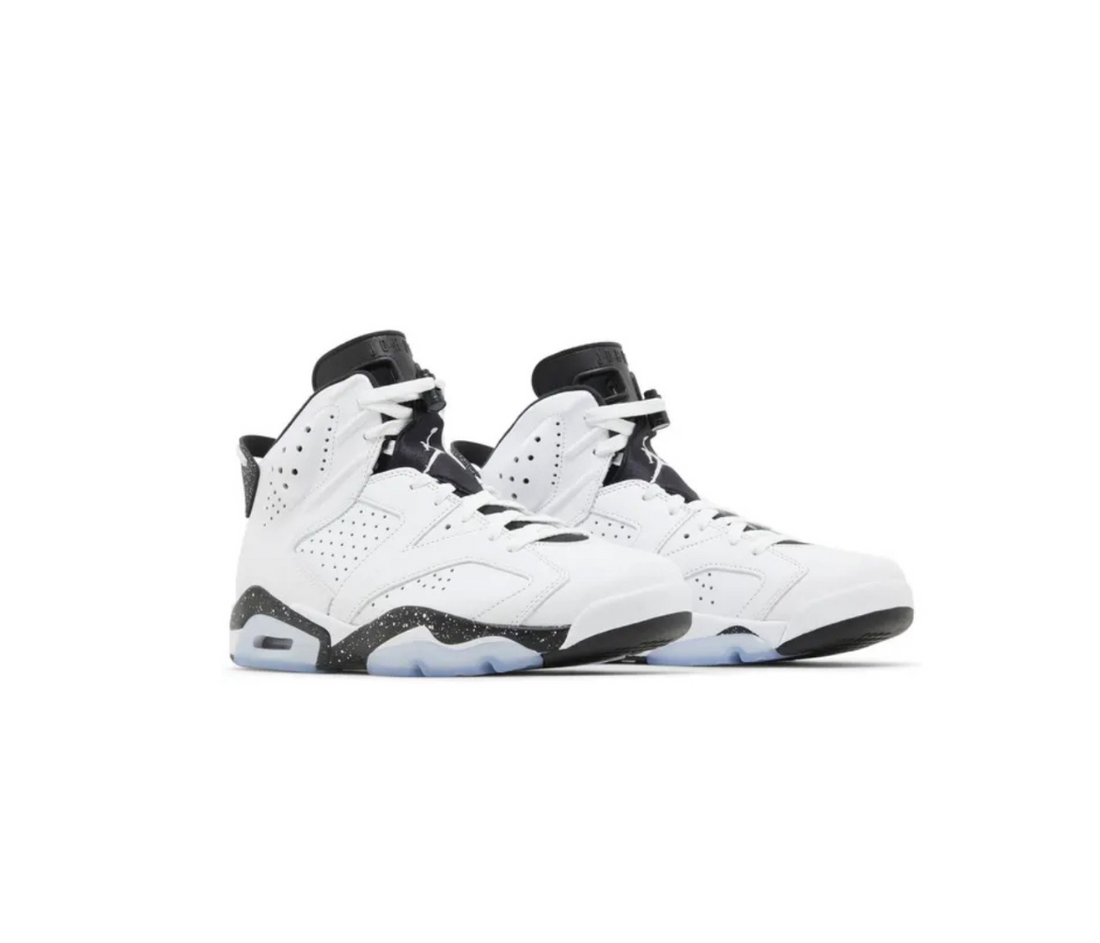 Pair of Air Jordan 6 sneakers in white and black colorway, featuring perforated leather upper and icy translucent rubber outsole.