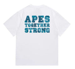 A white t-shirt featuring the phrase "APES TOGETHER STRONG" on the back, with the text in bold blue camouflage lettering.