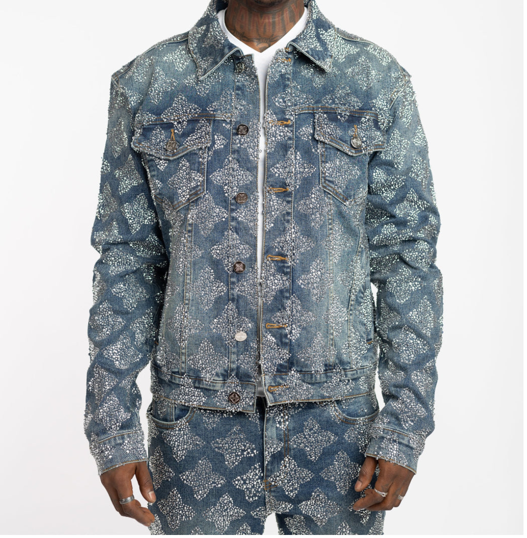 Man wearing matching denim jacket and pants covered with silver glitter dots in a diamond pattern, white shirt underneath.