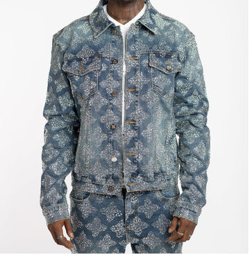 Man wearing matching denim jacket and pants covered with silver glitter dots in a diamond pattern, white shirt underneath.