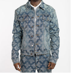 Man wearing matching denim jacket and pants covered with silver glitter dots in a diamond pattern, white shirt underneath.