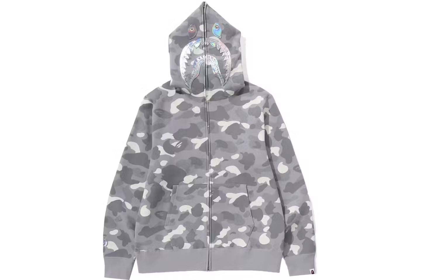 A gray camouflage BAPE hoodie with a shark face graphic on the hood, featuring a zipper and front pockets.