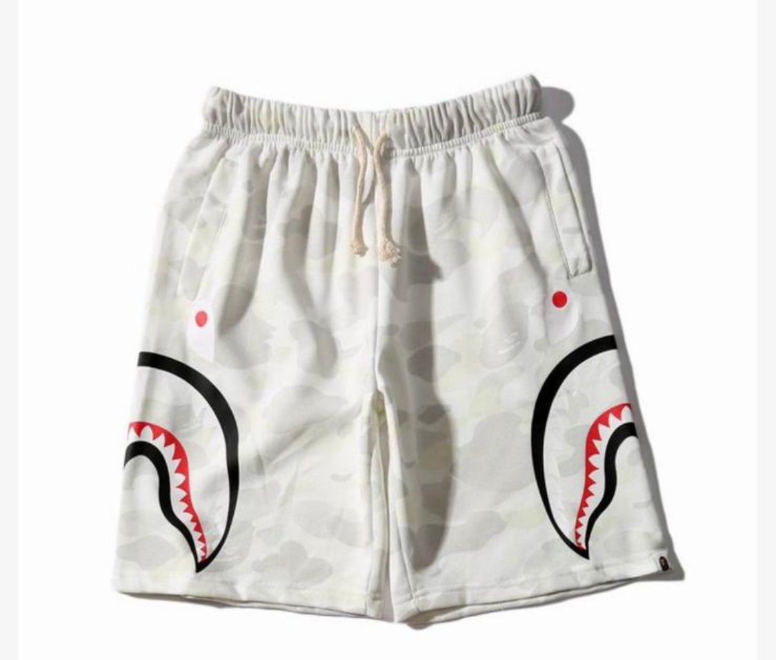 White camouflage shorts featuring a bold shark design on both sides, with red and black details.