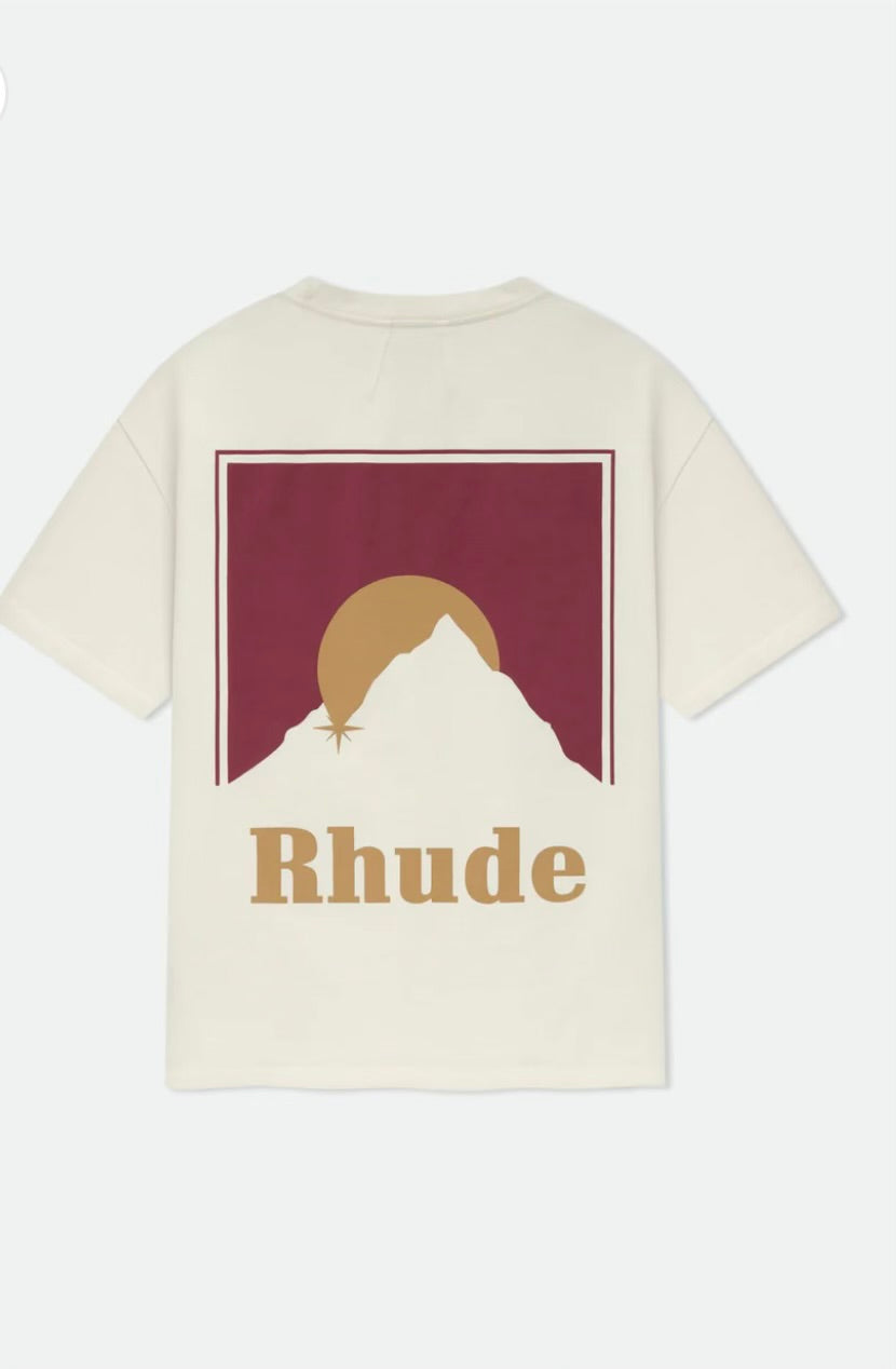Cream oversized T-shirt with a maroon and gold graphic logo featuring a mountain and the letter R on the chest.