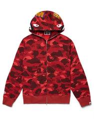 A red BAPE zip-up hoodie with a camouflage pattern, featuring bold eye graphics on the hood and branding on the sleeves.