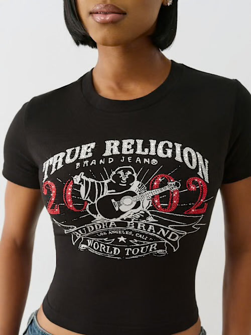 Woman wearing a black crop top with “True Religion 2002 Buddha Brand World Tour” graphic featuring a guitar-playing Buddha design.