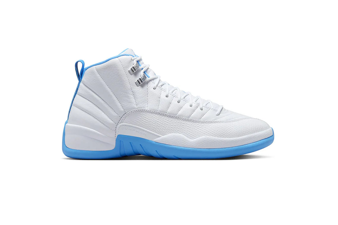 White Air Jordan 12 sneaker with textured leather upper, blue accents on midsole and lining, silver eyelets, and stitched panel detailing.