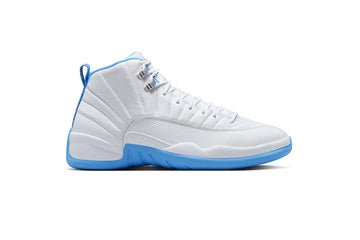 White Air Jordan 12 sneaker with textured leather upper, blue accents on midsole and lining, silver eyelets, and stitched panel detailing.
