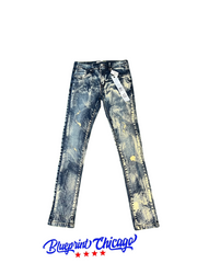 Distressed denim jeans with a light wash, featuring yellow paint splatter details and a tag attached, displayed with Blueprint Chicago logo.