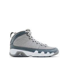 A side view of a grey and white Air Jordan 9 sneaker with a smooth leather upper and a white midsole featuring a Jumpman logo.