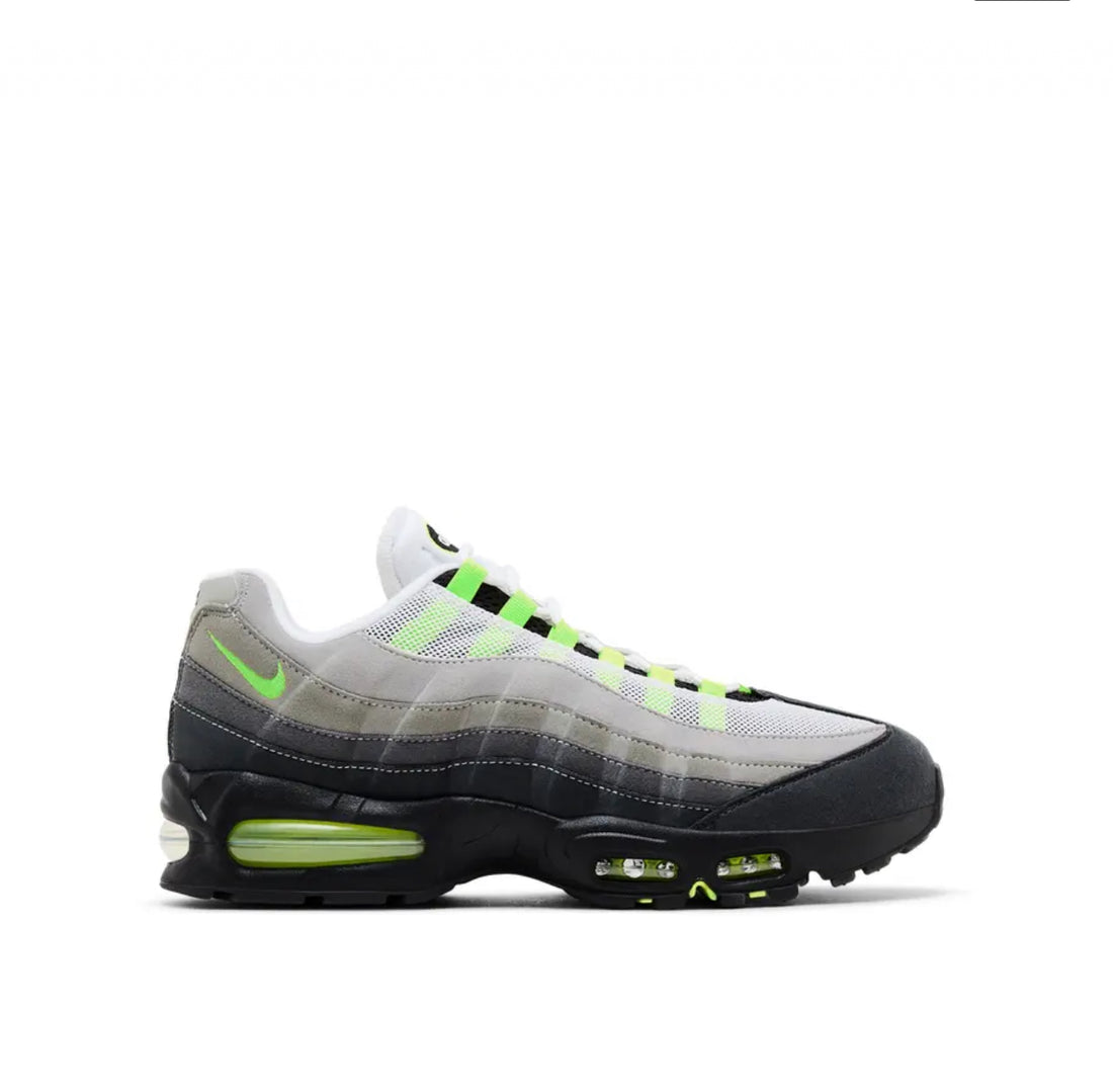 Side view of Nike Air Max 95 sneaker with gradient gray shades, black sole, neon green air unit, and white mesh upper.