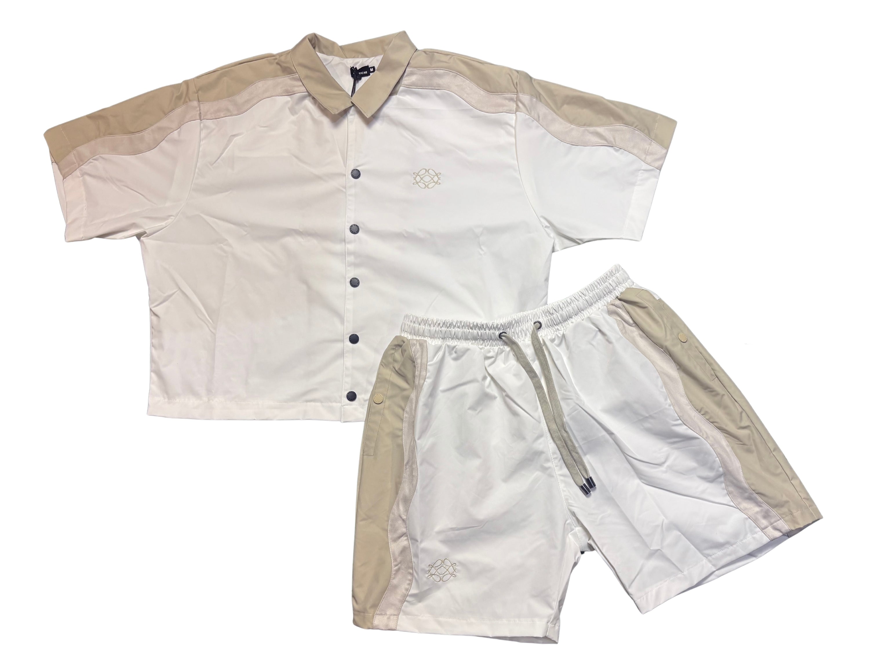 Two-piece cream and beige button-up shirt and shorts set with a subtle logo design, drawstring waist, and contrasting shoulder panels.