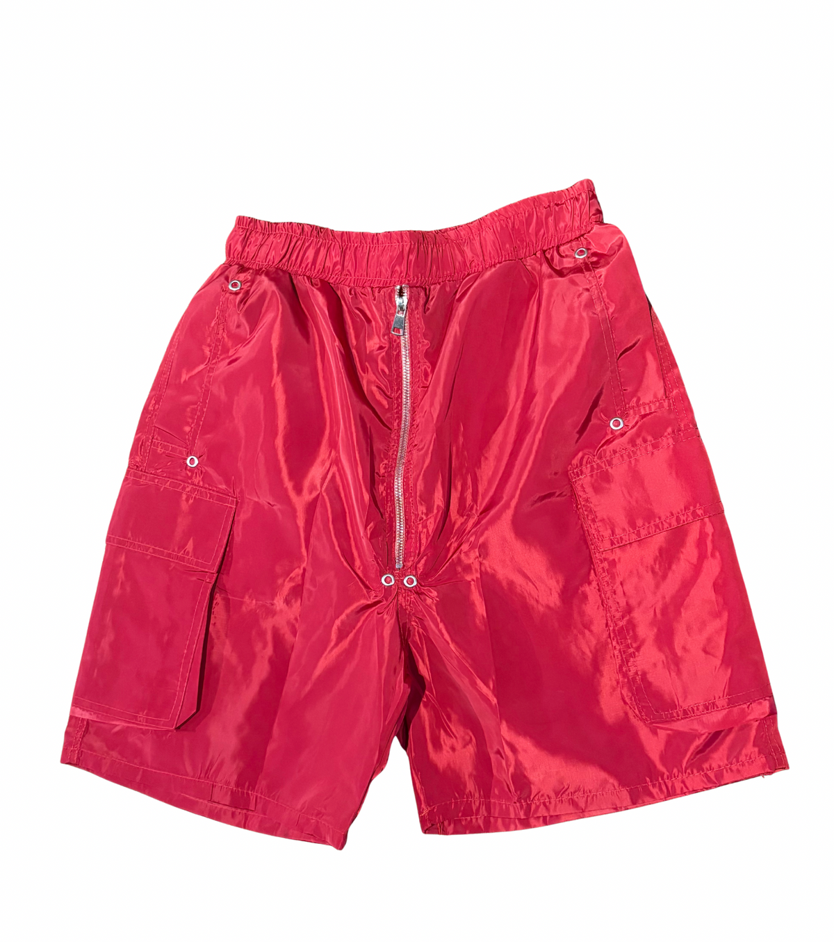 Bright red shiny nylon shorts with elastic waistband, silver zipper front, and large flap pockets on each side against white.