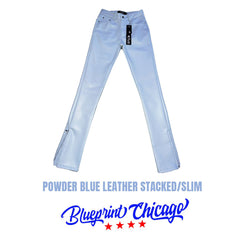 Powder blue leather stacked/slim pants with a sleek finish, featuring a brand tag attached to the waistband and zipper cuffs.